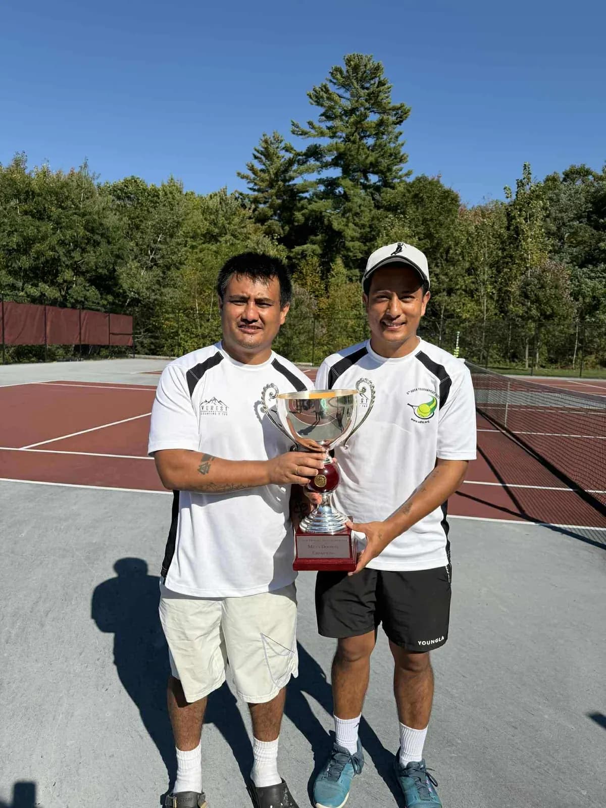 Lifting trophy by Men's Doubles winner